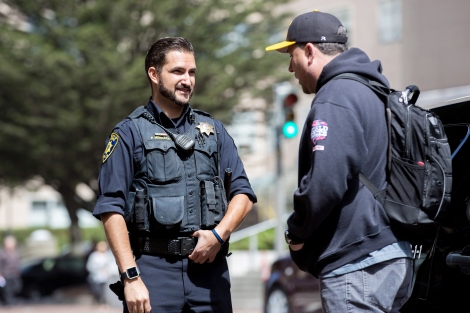 UCSF Police Officer Patrick Moncada talks with off-duty Sergeant Che Heron.