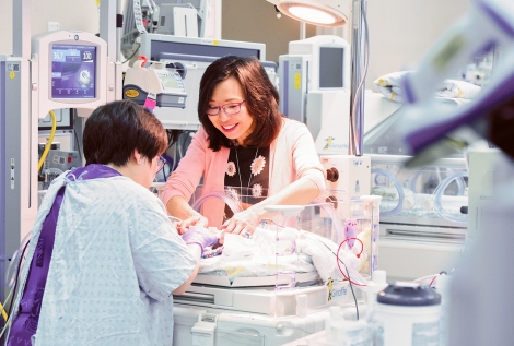 Jayalakshmi Ravindran examines a patient in the neonatal intensive care unit at UCSF Benioff Children’s Hospital Oakland
