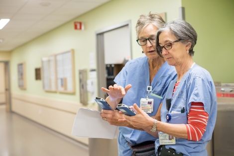 Therese Moran and Judith Bishop use handheld devices to monitor patients at the Betty Irene Moore Women’s Hospital at Mission Bay
