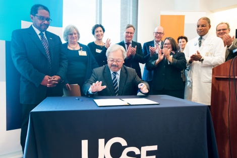 UCSF and ZSFG leaders stand behind Mayor Ed Lee while he signs legislation