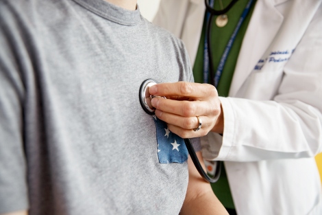 doctor places a stethoscope on a patient's chest