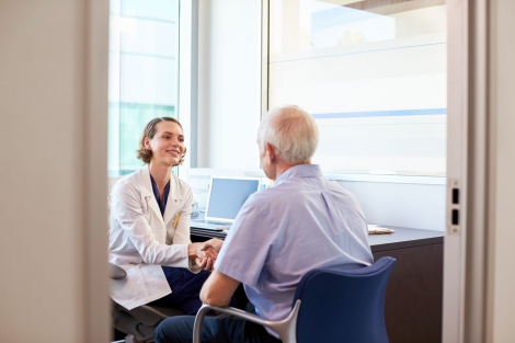 stock image of female doctor greeting a patient in her office
