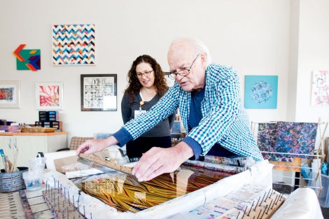 David Sandow shows an art piece to Dr. Margot Kushel in his home