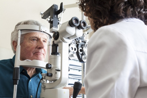 stock image of elderly man getting an eye exam