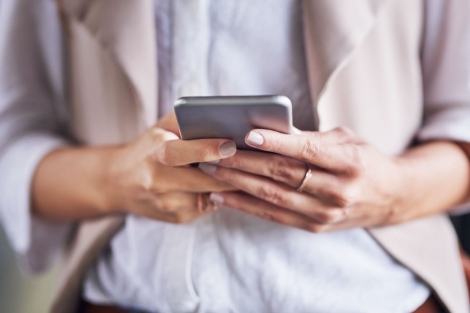 woman's hands holding a smartphone