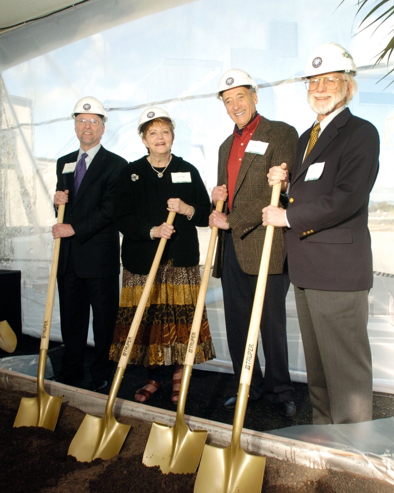 Peter Carroll, Helen Diller, Sanford Diller, and Mike Bishop pose with shovels and hard hats