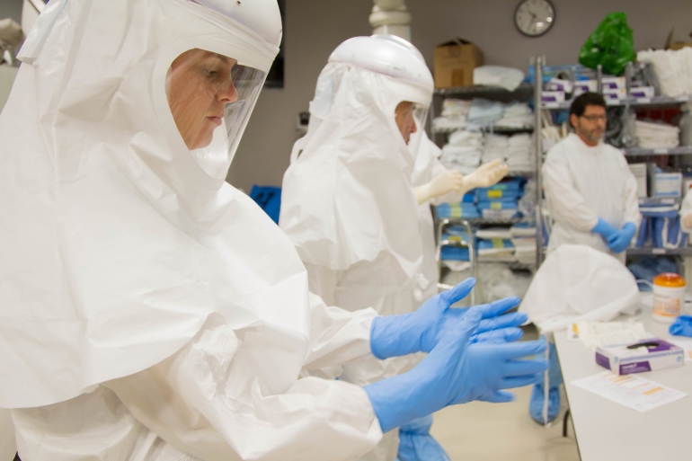 lab personnel in protective equipment.