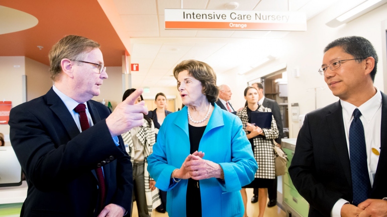 Dianne Feinstein walks with UCSF leaders on a hospital tour