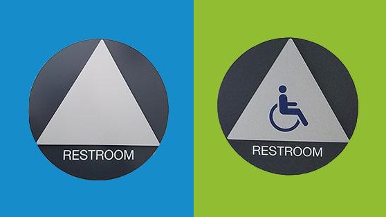 Restroom signage of a triangle inside of a circle and a wheelchair pictogram on a triangle inside of a circle