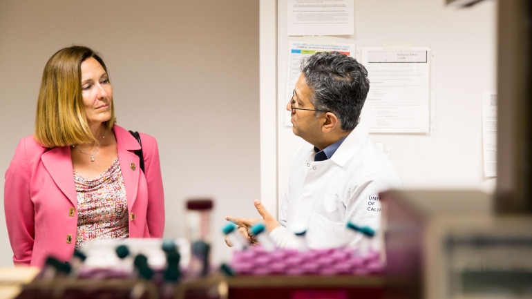 Jacqui Irwin talks with Shuvo Roy in a lab