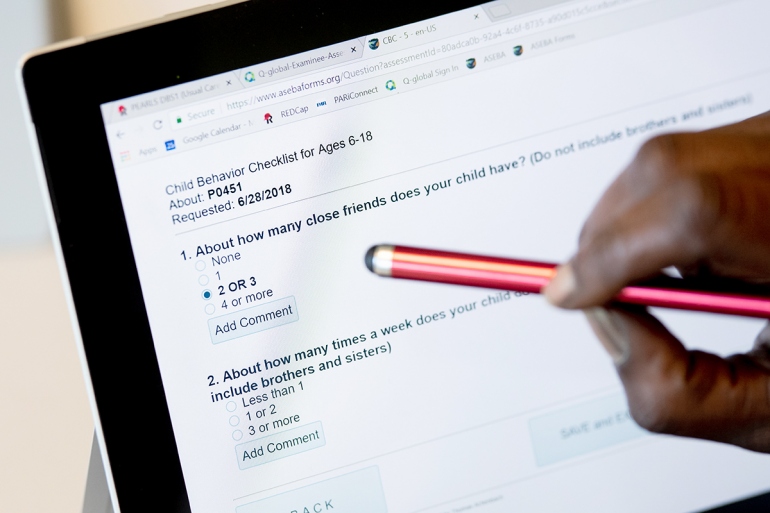 a stylus points at questions on an iPad