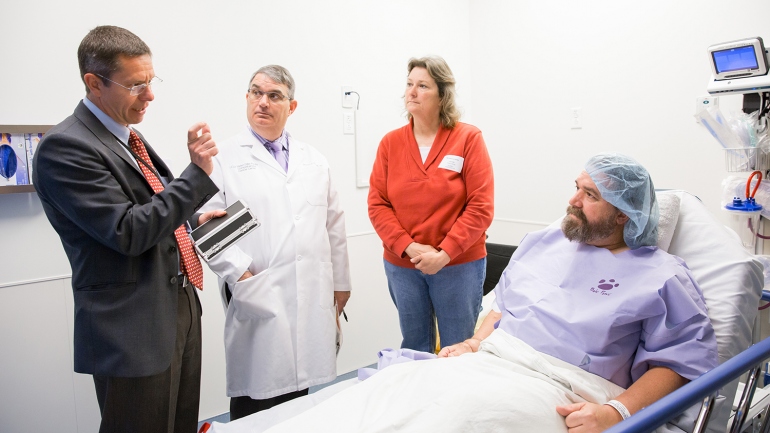 ickard Branemark, MD, PhD, MS; Richard O'Donnell, MD; Teresa Kocelj; and George Kocelj talk in a hospital room before George's osseointegration surgery.