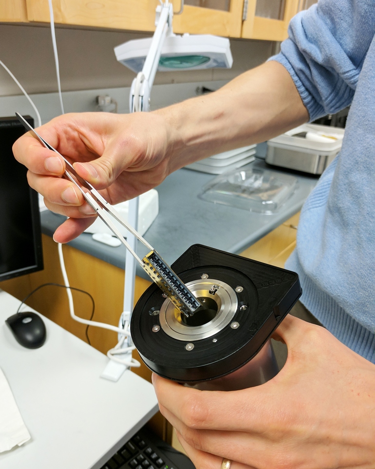 a researcher prepares a sample for the cryo-EM machine