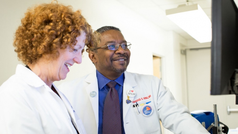Talmadge King consults with Sally McLaughlin, a nurse in the Interstitial Lung Disease Program in UCSF Medical Center.