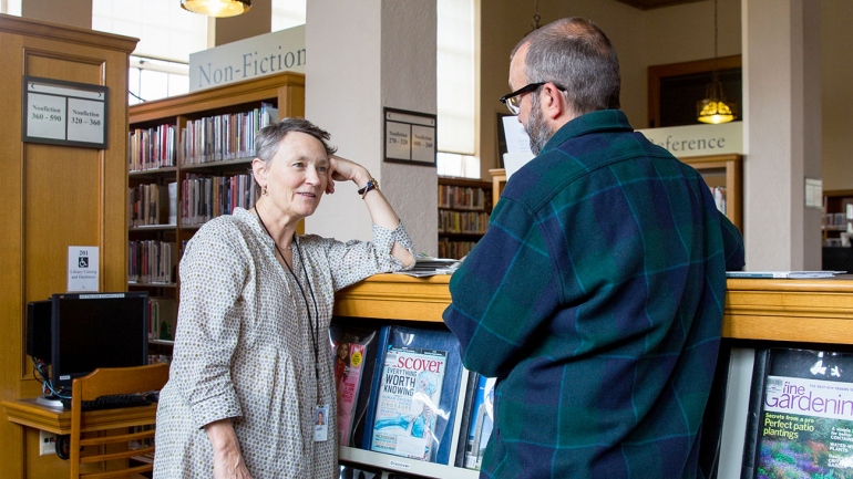 Valerie Reichert talks to a library patron