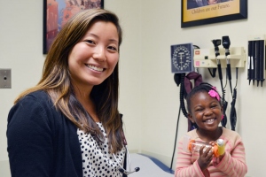 Kimberlee Honda poses with a young patient at SFGH