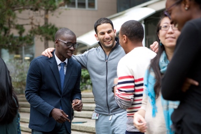 Pharmacy student Omar Diarra (far left) and medical students Onur Yenigun (center) and Donald Richards chat about their experiences as Curriculum Ambassadors at a gathering last month.