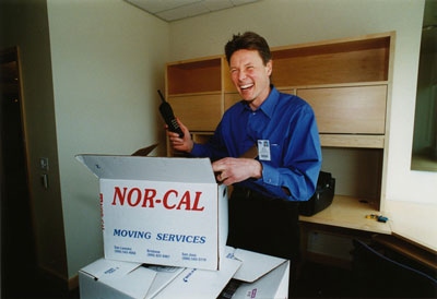 Charles Craik unpacks boxes at his new Mission Bay office in 2003.