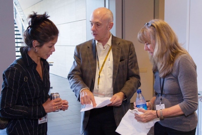 UCSF Chief Procurement Officer Jim Hine, center, discusses the UCSF2025 final  leader totals with Brenda Gee, left, and Suya Caldwell, right, of the Executive Vice  Chancellor and Provost's Office.
