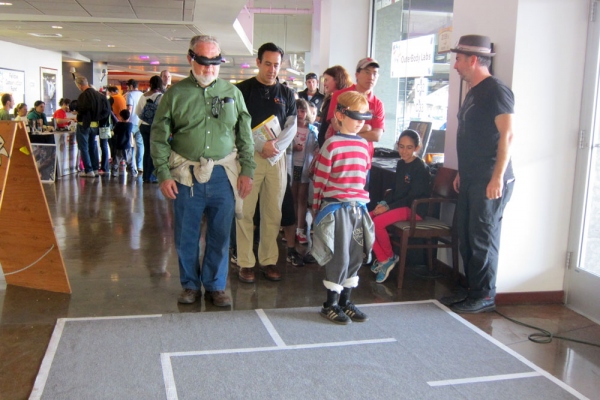 Participants navigate a maze wearing virtual reality headsets.