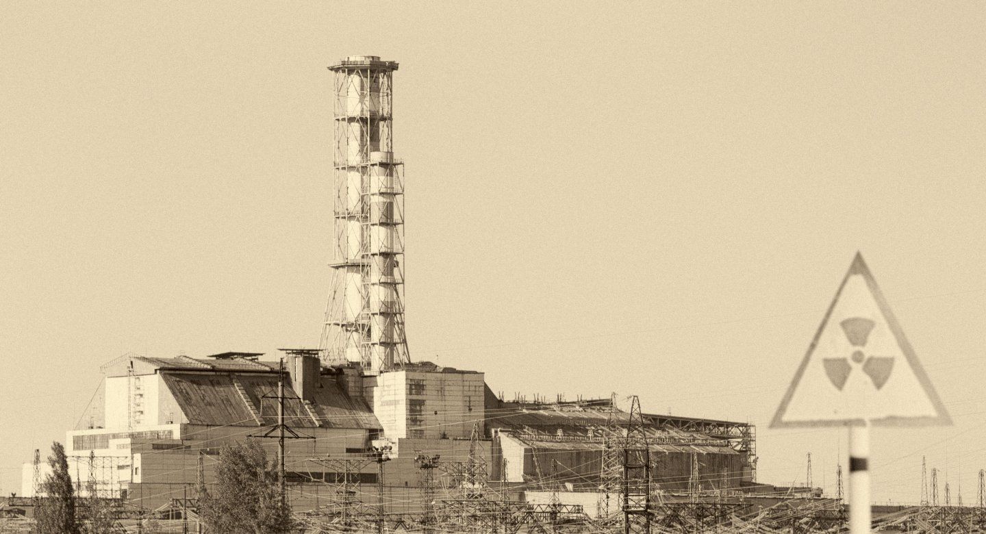 Chernobyl power plant with radioactive sign in foreground