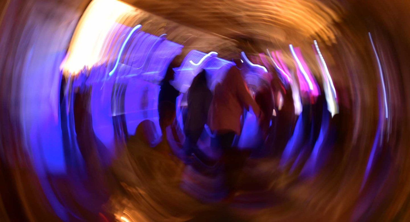 A distorted image showing a group of people walking.