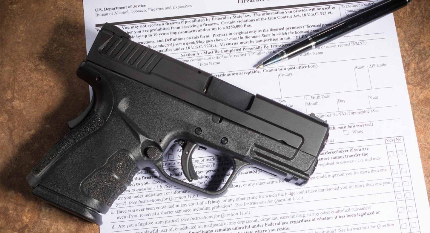 A gun and a firearm registration document.