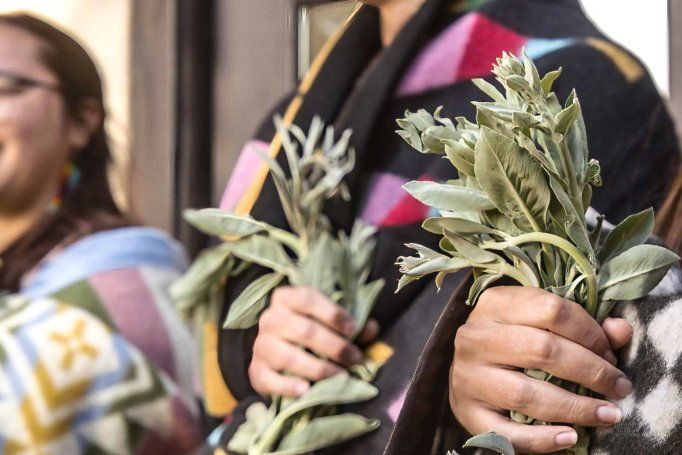 smiling graduate holds herbal bouquet 