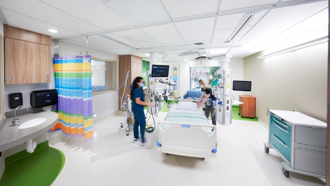 two staff members work in the a ICU room