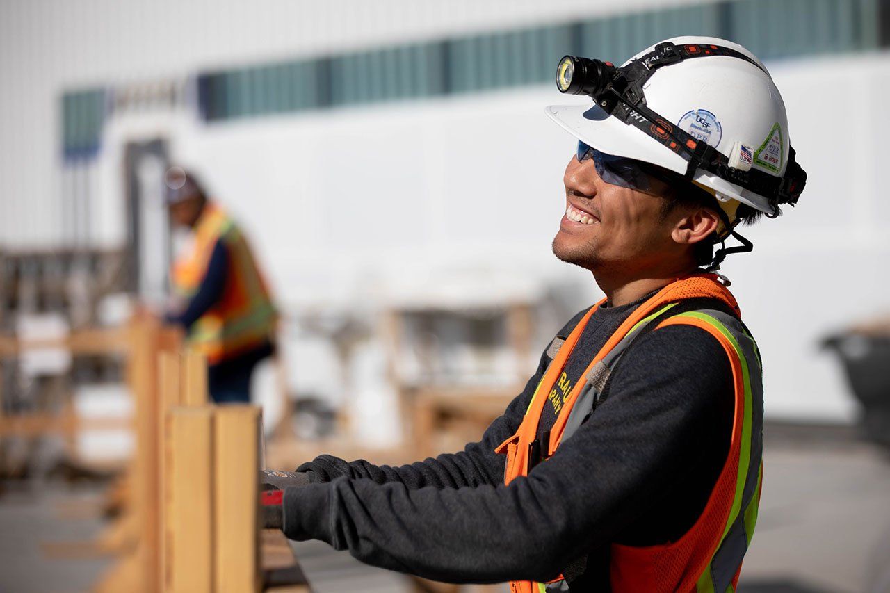 Construction worker Stanley Chen laughing on a break at his job site