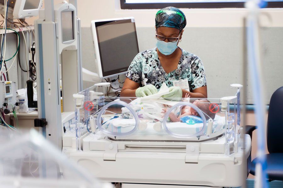 A nurse tends to a baby at the Benioff Children's Hospital Oakland Neonatal Intensive Care Unit
