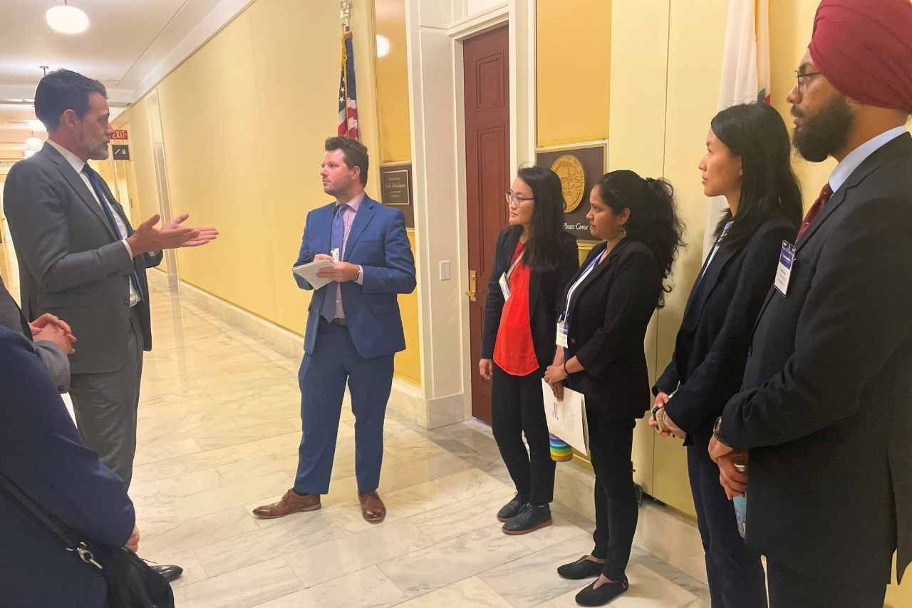 UCSF researchers speak to delegate in hallway of White House