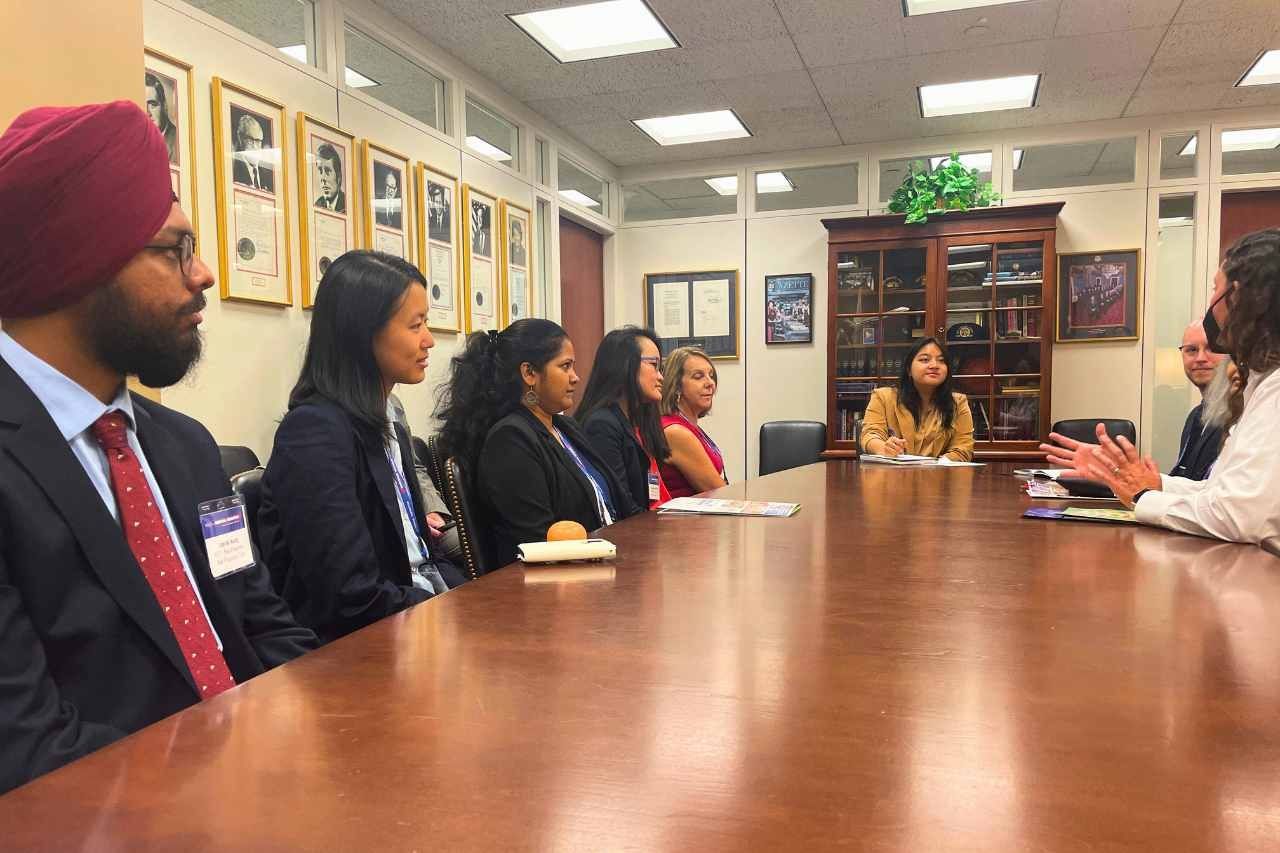 students sit a large table meeting with U.S. Sen. Dianne Feinstein