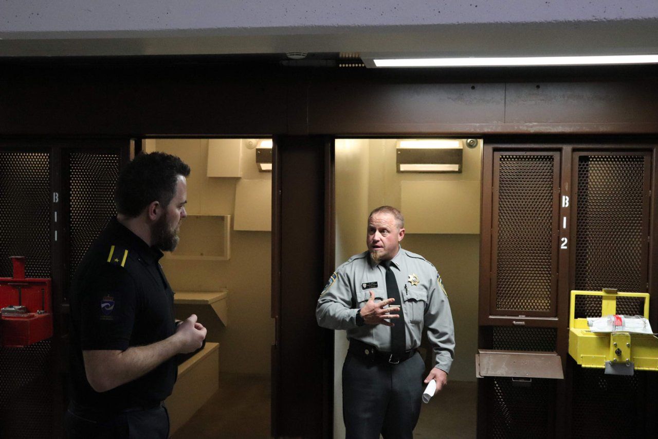 Oregon State Penitentiary officer Dave, right, talks with a trainer from the Norwegian Correctional Service in a prison.