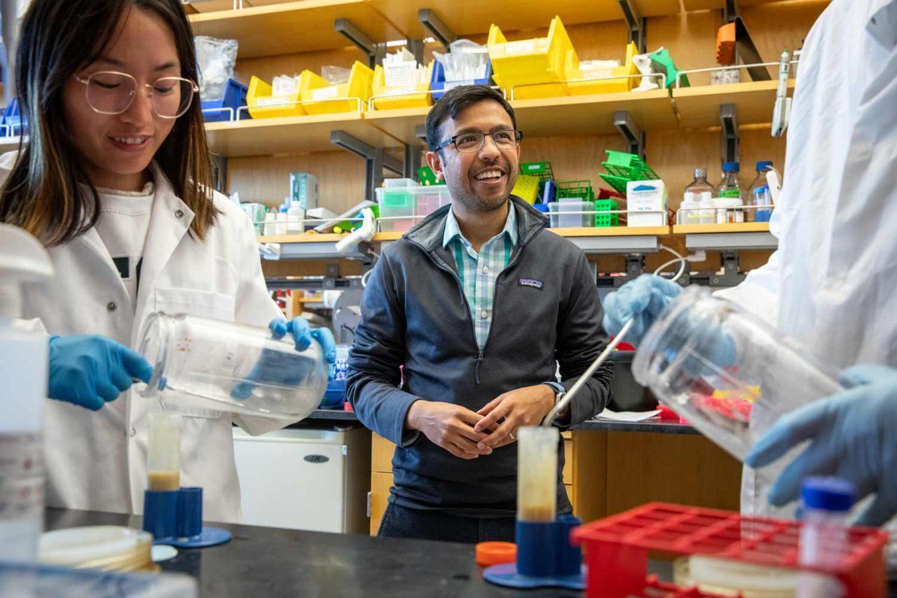 Aashish Manglik (center), postdoctoral student Huixia Wang (left), and graduate student Sruthi Raguveer talk together as they conduct research in Manglik's lab.
