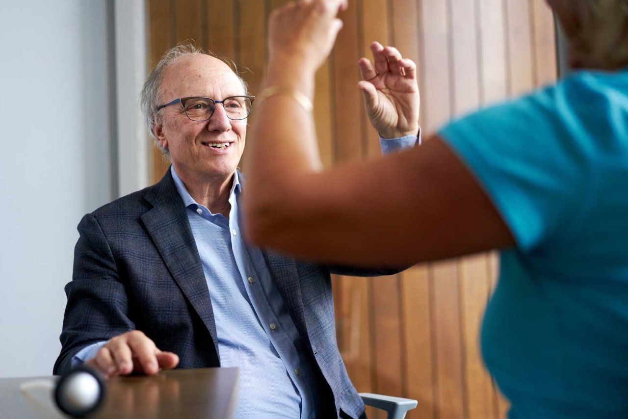 Bruce Miller conducts coordination exams on a patient.