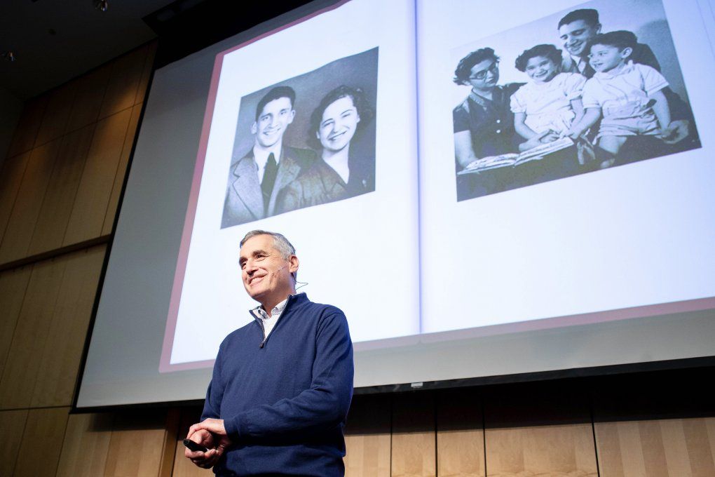family photos project behind David Wofsy as he delivers a Last Lecture in Cole Hall