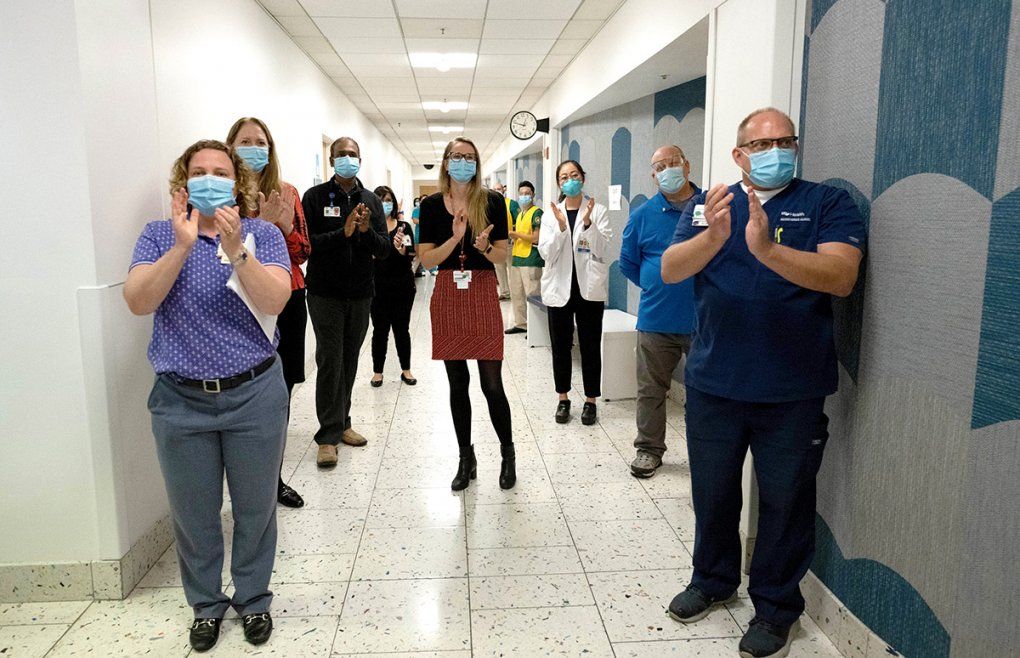 UCSF medical workers applaud the first vaccinations