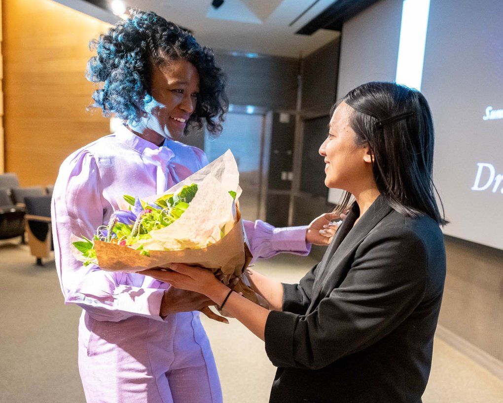 Kai Kennedy smiles as she accepts flowers after her Last Lecture presentation