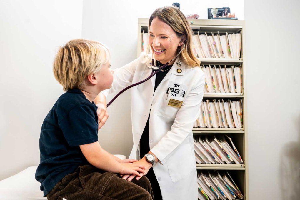 Melissa Fesler examines a toddler-aged boy.