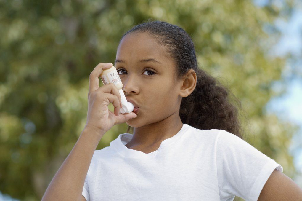 Young girl using an inhaler 