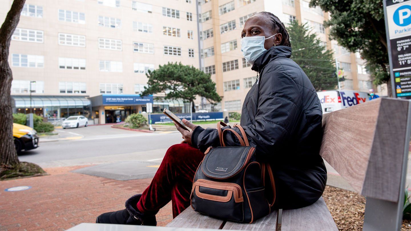 Rashetta Higgins sits on a bench outside of the UCSF Medical Center at Parnassus Heights 