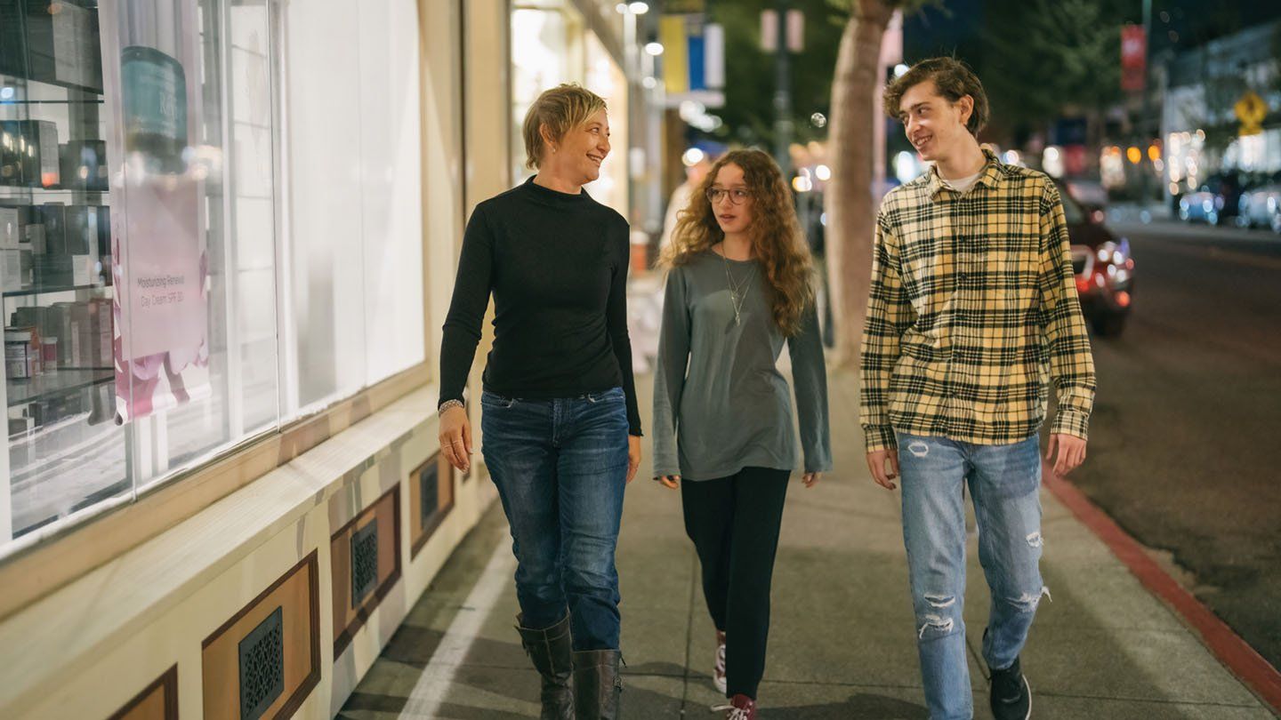 Angie Jacobson walks with her son and daughter down a street in San Francisco