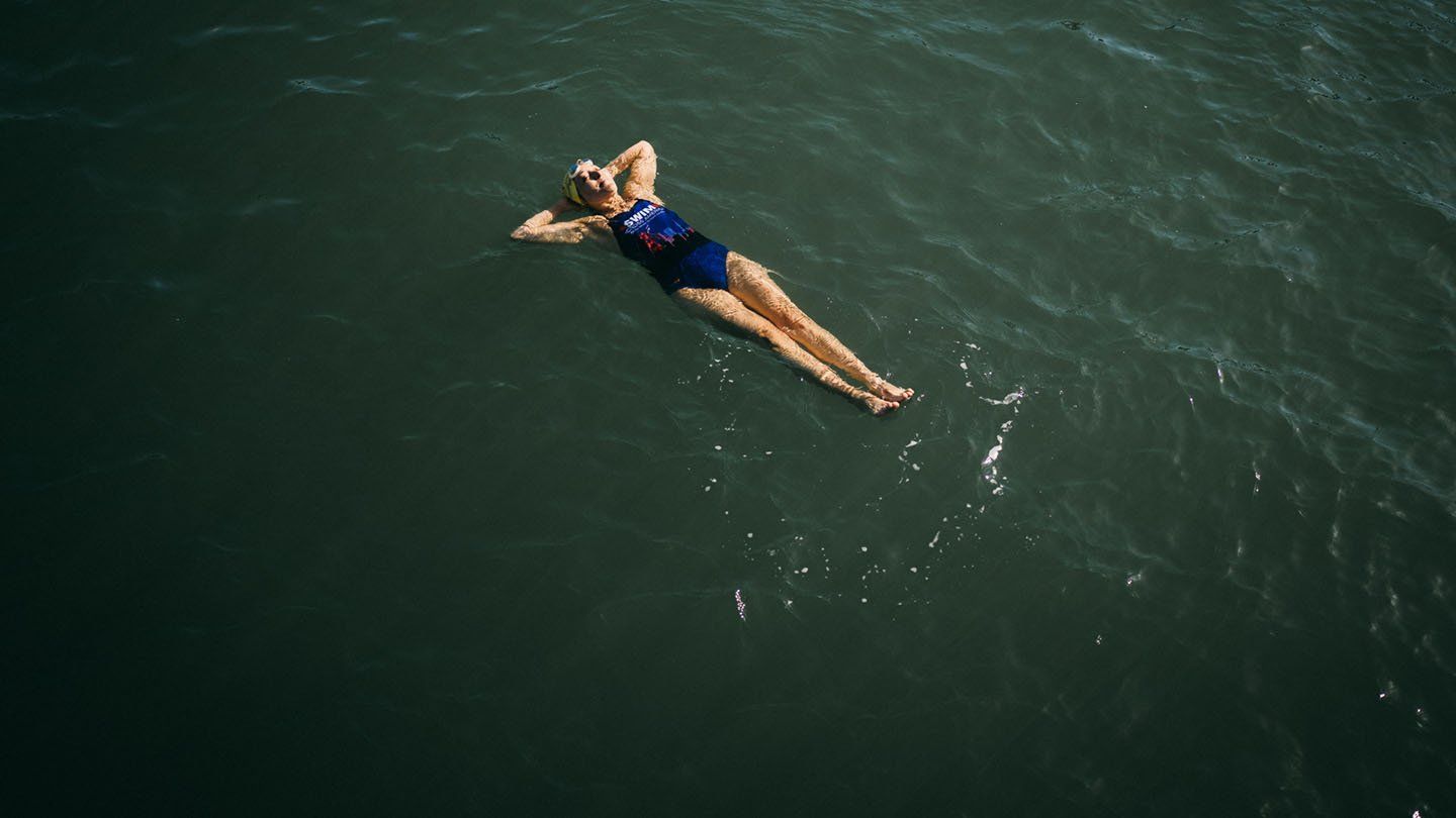 Angie Jacobson floats on her back in the bay