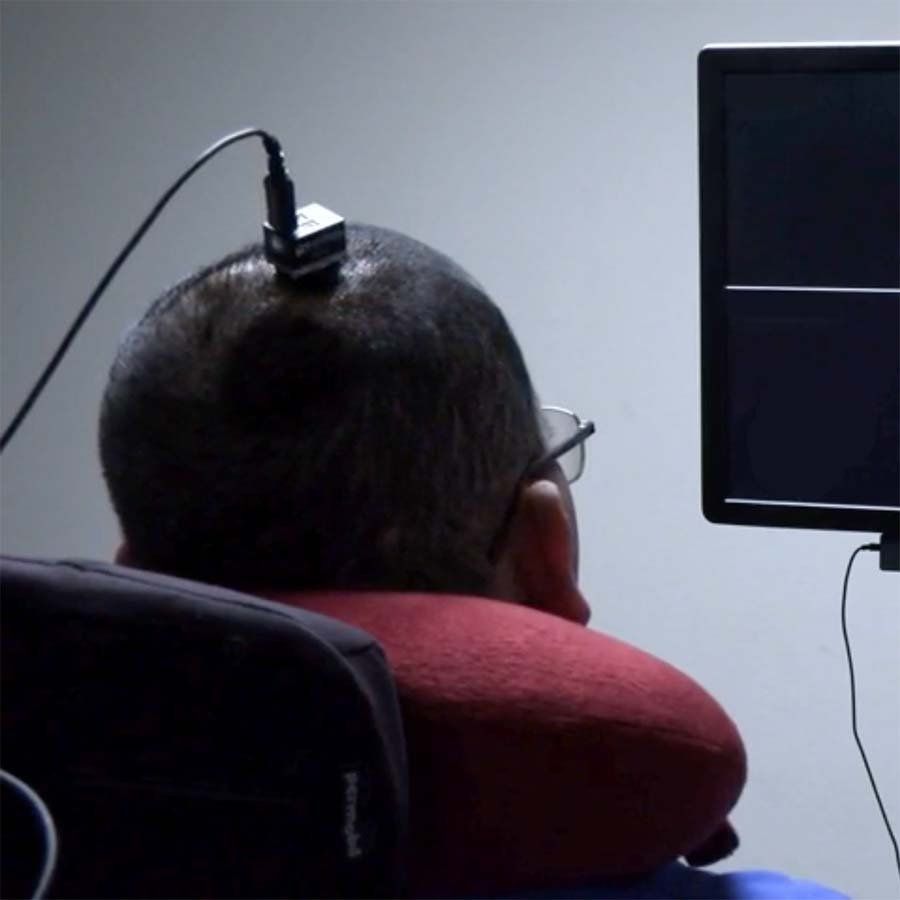 Patient with a neuroprosthesis responding to prompts on a screen