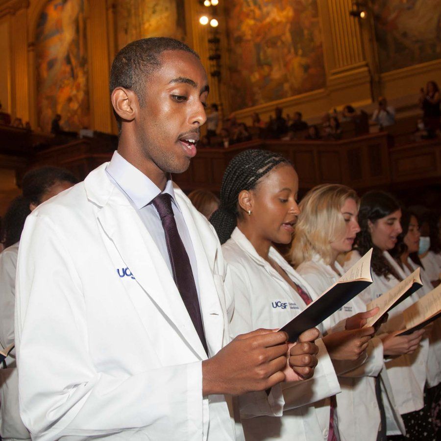 Students read from booklets the UCSF Physicians Declaration during the School of Medicine White Coat Ceremony