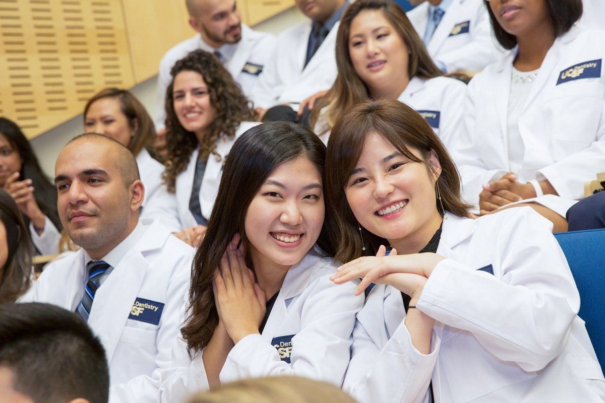 Yoo Jung Chung and Chae Jin Kim smile for the camera during the School of Dentistry’s white coat ceremony