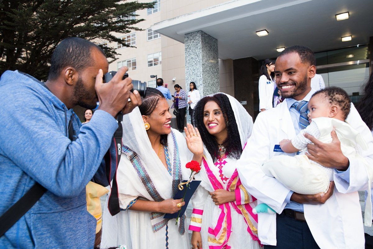 First-year UCSF School of Pharmacy student Tek Teklehaimanot celebrates with family after the white coat ceremony