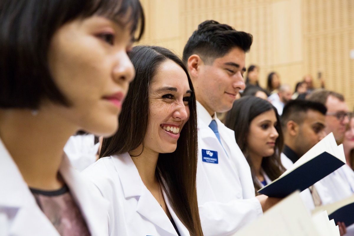 New School of Pharmacy students standing during white coats ceremony