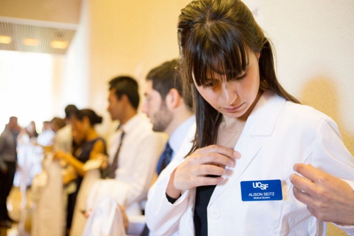 student adjusts name tag 